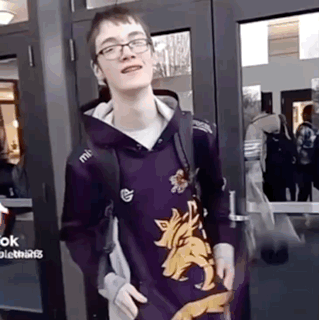 Young Man in Purple Hoodie With Wolf Standing at Door