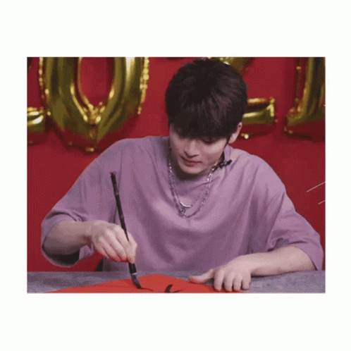Young Man in Purple Shirt Holding Brush