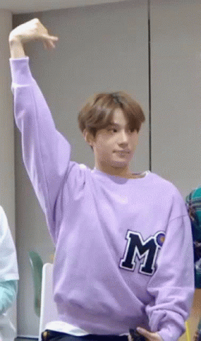 Young Man In Purple Sweatshirt Raising Arm GIF