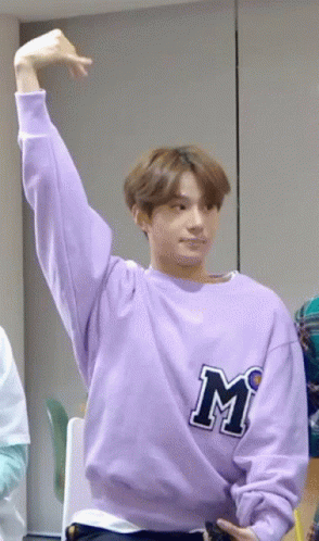 Young Man in Purple Sweatshirt With Letter M