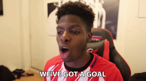 Young Man in Red and White Shirt Saying Goal