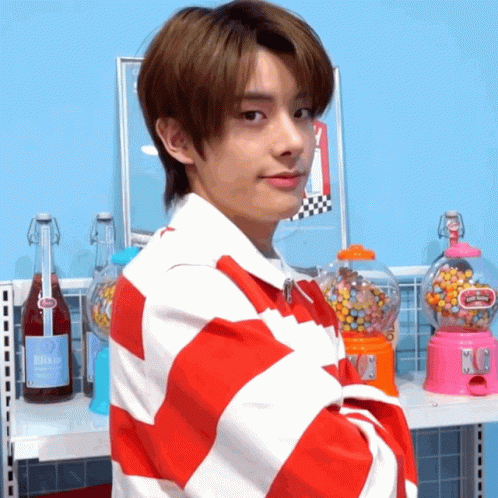 Young Man In Red And White Striped Shirt At Gumball Machine GIF