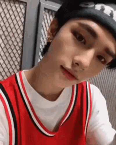 Young Man in Red Basketball Jersey and Black Beanie