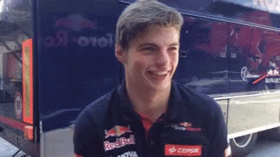 Young Man In Red Bull Shirt Smiling Near Bus GIF