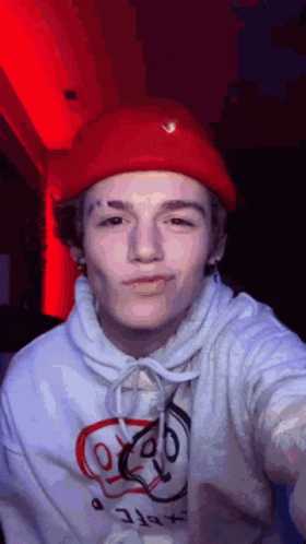 Young Man in Red Hat and White Hoodie