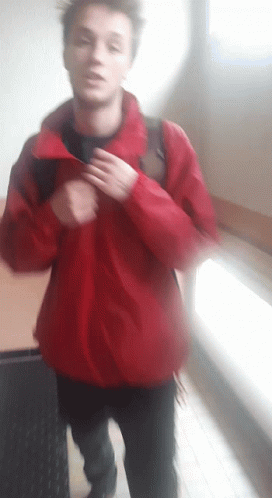 Young Man In Red Jacket Walking GIF