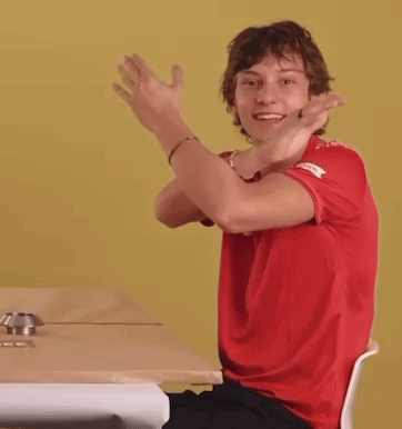 Young Man in Red Shirt Head Down at Table