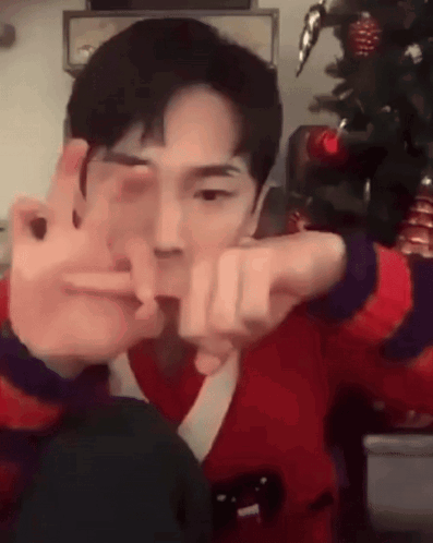 Young Man in Red Sweater Making Peace Sign