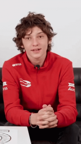 Young Man in Red Sweatshirt With ACT on Sleeves