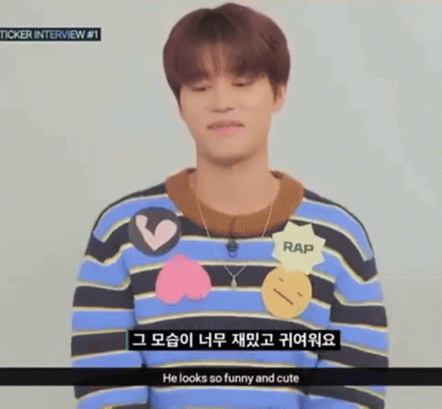 Young Man in Striped Sweater and Necklace Talking Foreign Language