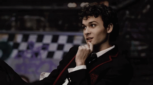 Young Man in Suit and Tie Finger on Chin