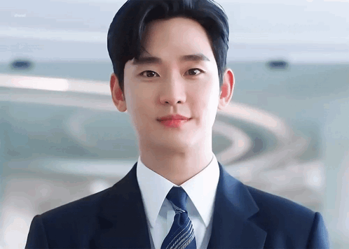 Young Man In Suit And Tie Looking At Camera GIF