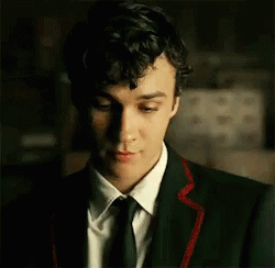 Young Man in Suit and Tie Looking Down