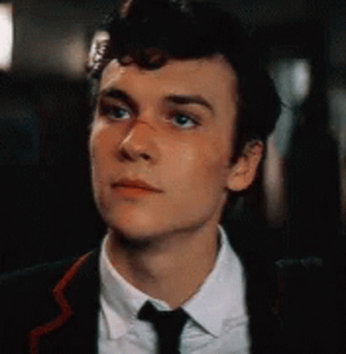 Young Man in Suit and Tie Looking Up
