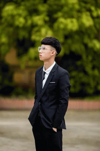 Young Man in Suit and Tie With Hands in Pockets