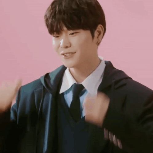 Young Man in Suit Giving Thumbs Up