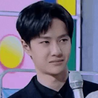 Young Man In Suit Holding Microphone GIF