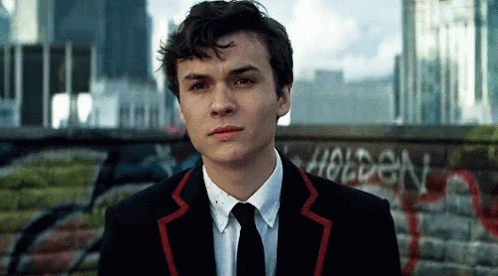 Young Man in Suit in Front of Holden Wall