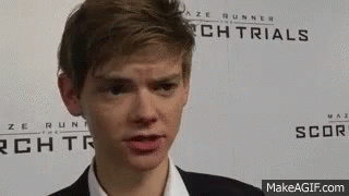 Young Man In Suit In Front Of Maze Runner Sign GIF