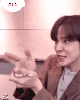 Young Man in Suit Making Funny Face with Hands Out