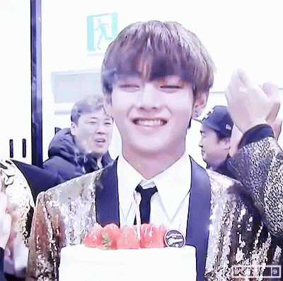 Young Man in Suit Smiling with Cake and Strawberries