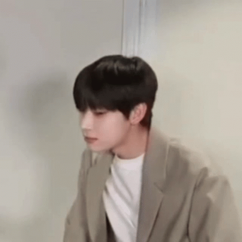 Young Man In Suit Standing By Door GIF