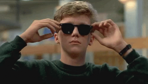 Young Man in Sunglasses Adjusts Glasses