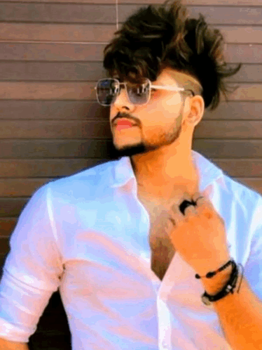 Young Man In Sunglasses Leaning Against Wooden Wall GIF