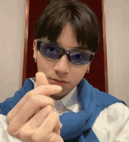 Young Man in Sunglasses Making Heart