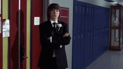 Young Man in Tuxedo Next to Blue Lockers