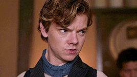 Young Man In Vest And Scarf Making Serious Face GIF