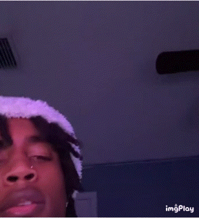 Young Man in White Hat and Purple Shirt Taking Selfie