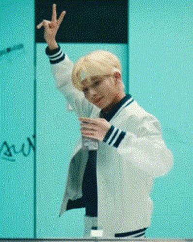 Young Man In White Jacket Making Peace Sign And Holding Water GIF