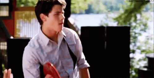 Young Man in White Shirt and Tie Holding Frisbee Talking