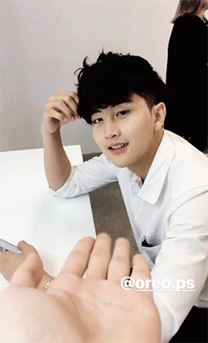 Young Man in White Shirt Hand Reaching Out