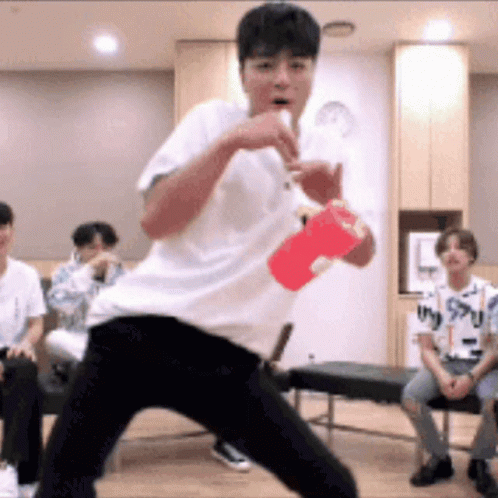 Young Man In White Shirt Holding Red Cup GIF