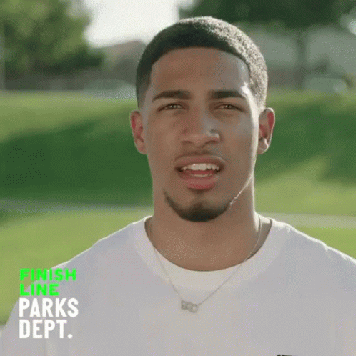 Young Man In White Shirt In Green Field GIF