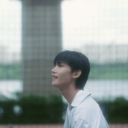 Young Man in White Shirt Looking Up