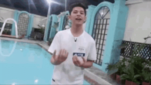Young Man In White Shirt Next To Pool GIF