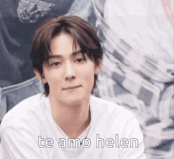 Young Man In White Shirt Sitting Looking At Camera GIF