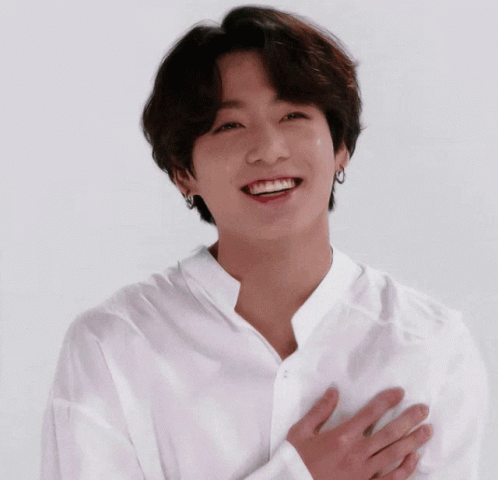 Young Man in White Shirt Smiling Hands to Chest