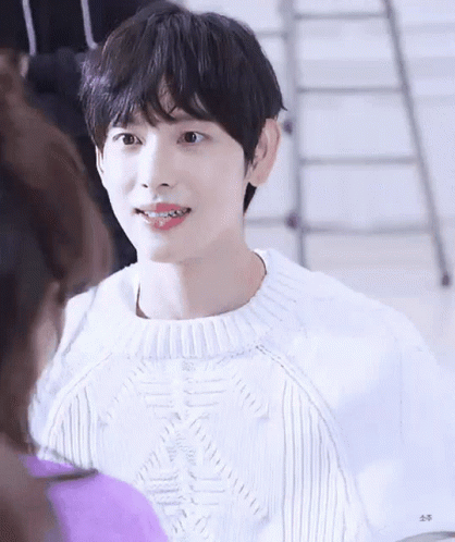 Young Man in White Sweater Smiling at Woman