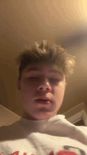 Young Man in White Sweatshirt With Letter G