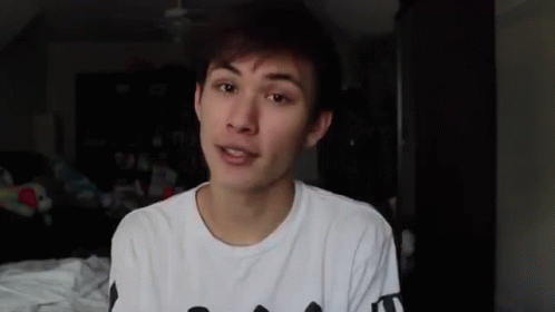 Young Man In White T-Shirt Talking To Camera GIF