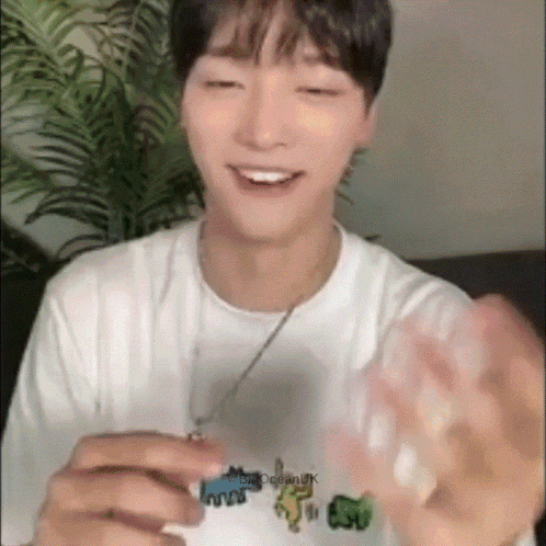 Young Man in White T-Shirt with Ocean Smiling