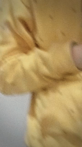 Young Man in Yellow Hoodie Taking Selfie