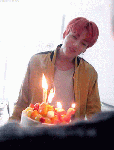 Young Man in Yellow Jacket With Birthday Cake