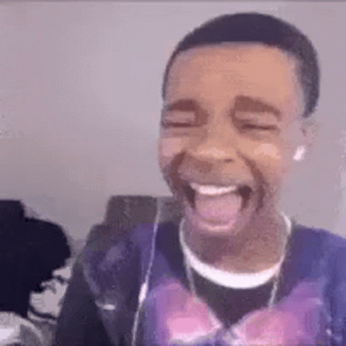 Young Man Laughing Tongue Out Headphones Purple Shirt