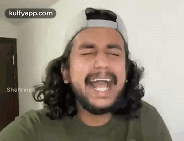 Young Man Laughing with Glasses and Purple Shirt