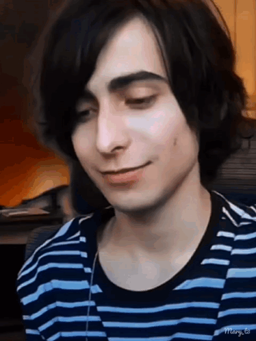Young Man Long Hair Smiling Blue-White Striped Shirt